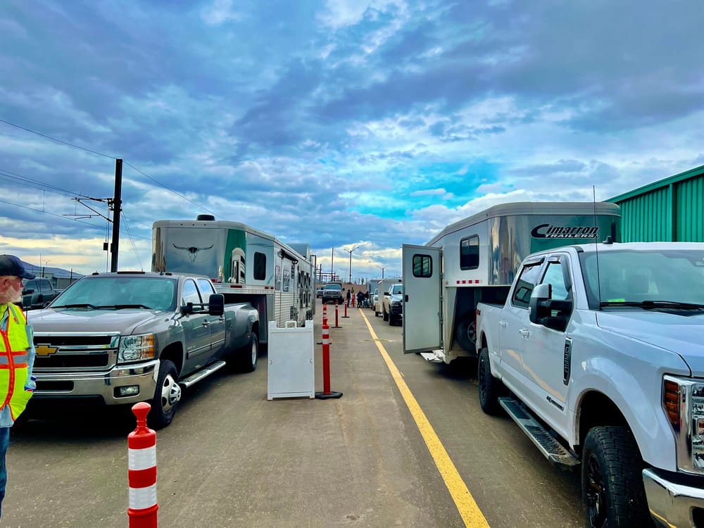 Traditional horse event check-in with long lines of trucks and trailers